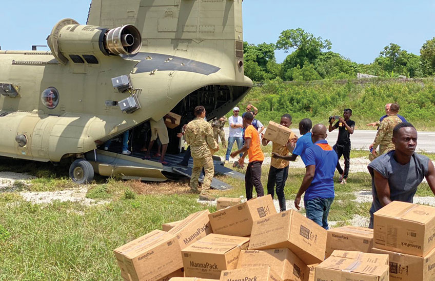 MannaPack boxes are unloaded from a military plane in Haiti