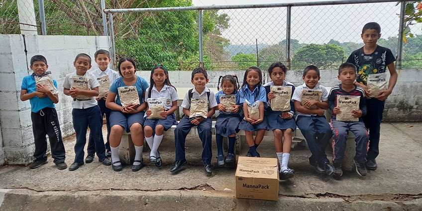 School children holding FMSC meals