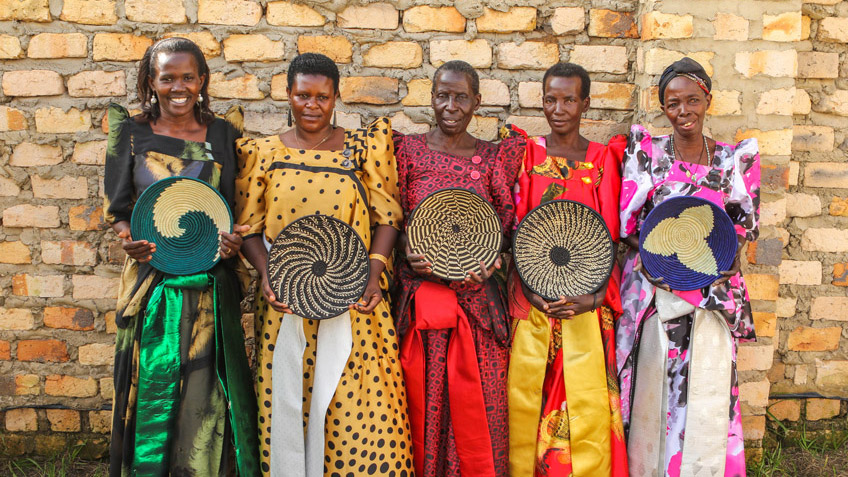 Ugandan women hold the ethically produced artisan goods they've made for FMSC's MarketPlace