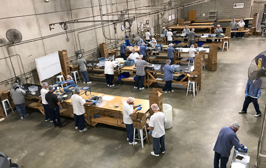 Incarcerated men pack Feed My Staving Children meals at the Faribault Correctional Facility in Faribault, Minnesota