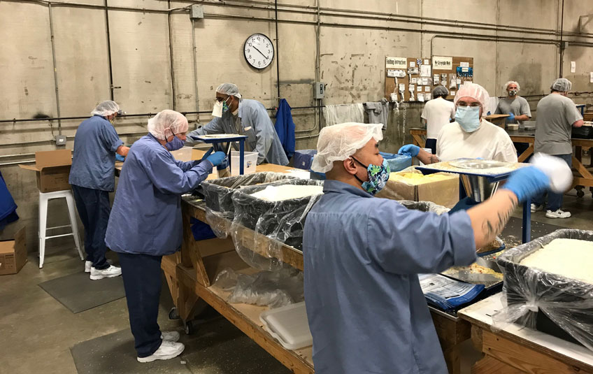 Incarcerated individuals packing FMSC meals at a correctional facility