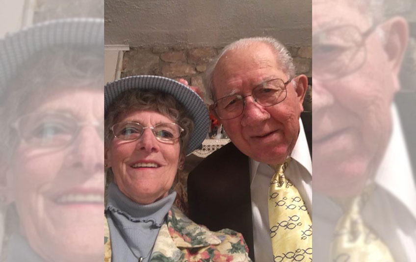 A selfie of elderly couple in formal attore