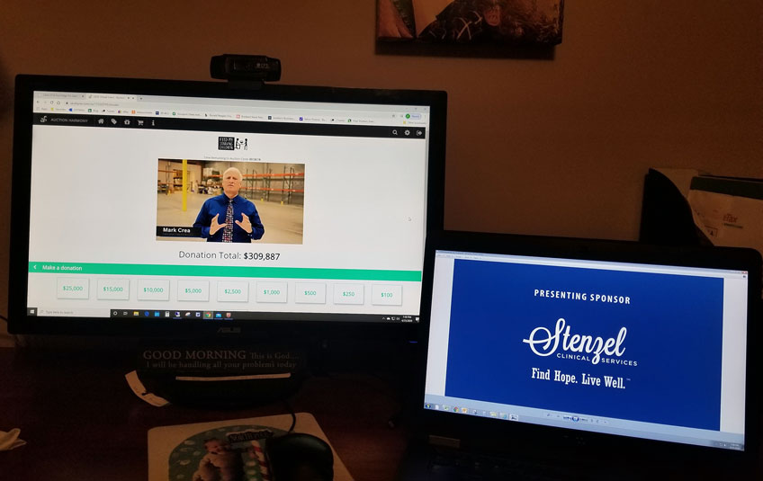 Two monitors, one showing FMSC's virtual gala and the other showing the logo of gala sponsor Stenzel Clinical Services
