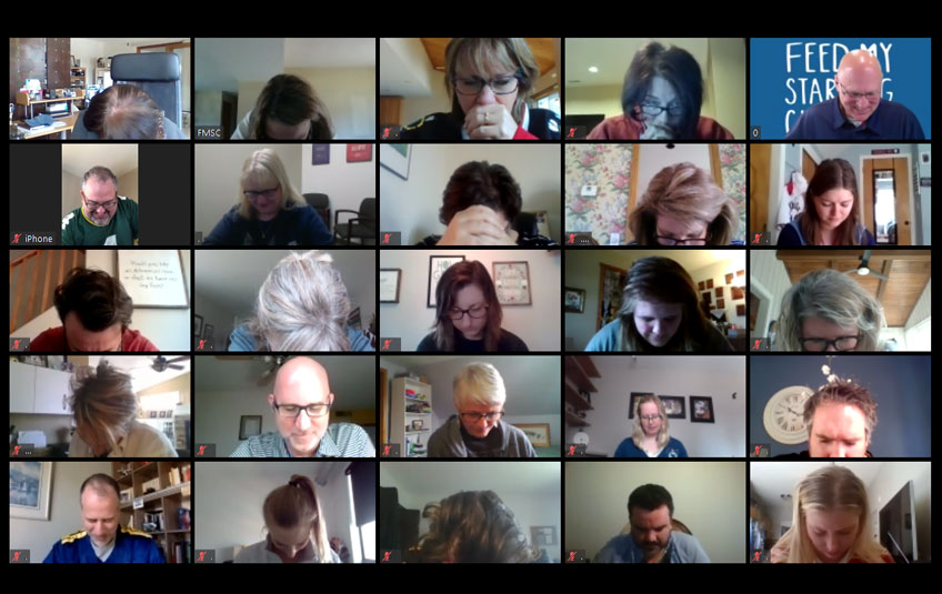Screenshot with tiled images of FMSC employees praying over a Zoom video conference