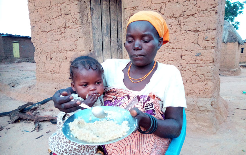 a mother feeds her daughter FMSC'S MannaPack meals
