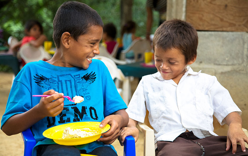 two boys eating FMSC food