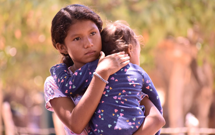 Girl holding a toddler