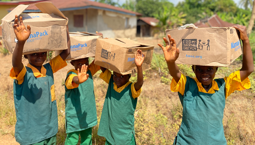 Children carrying FMSC food boxes