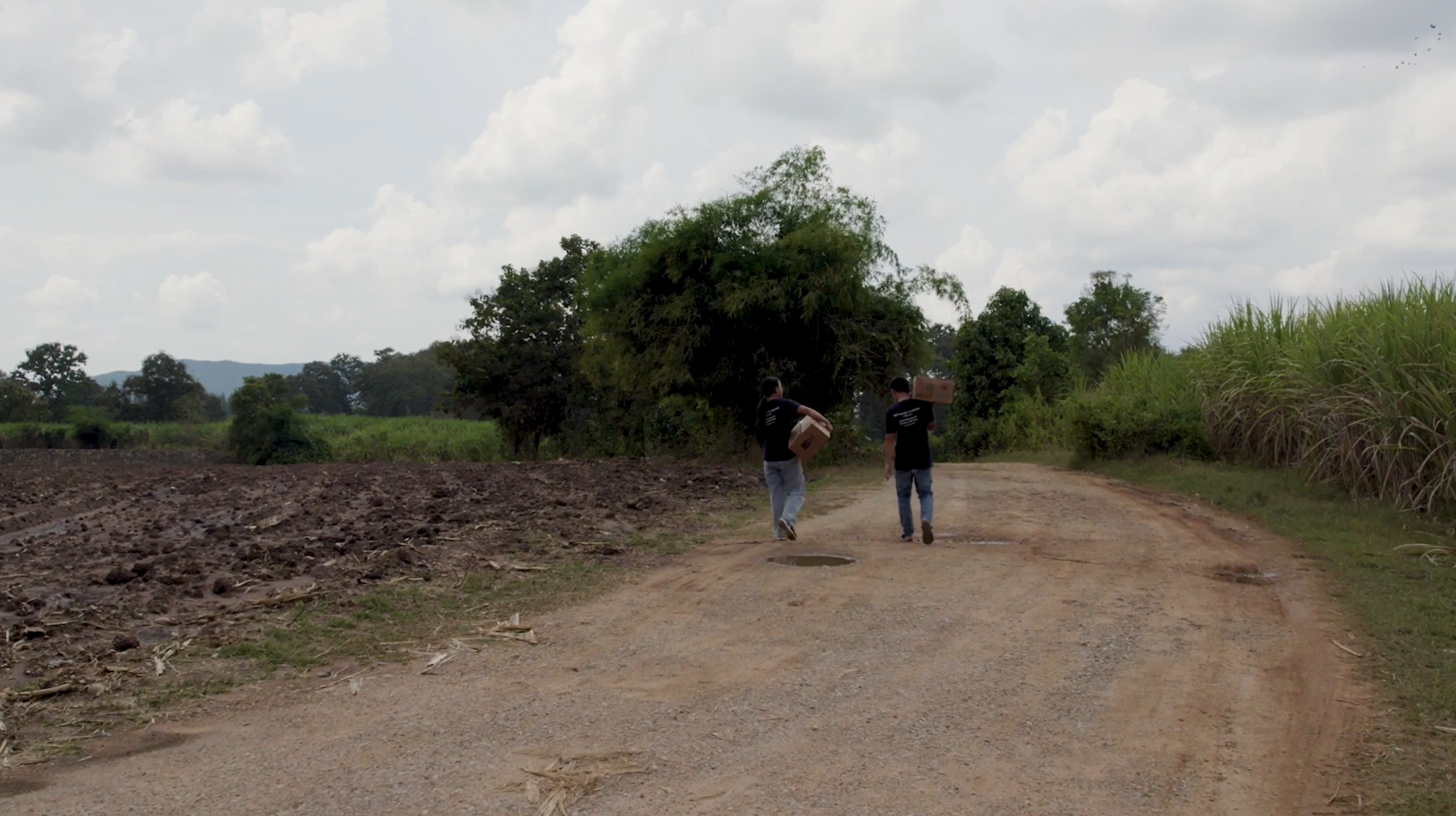 People walking down a road with FMSC food in Myanmar