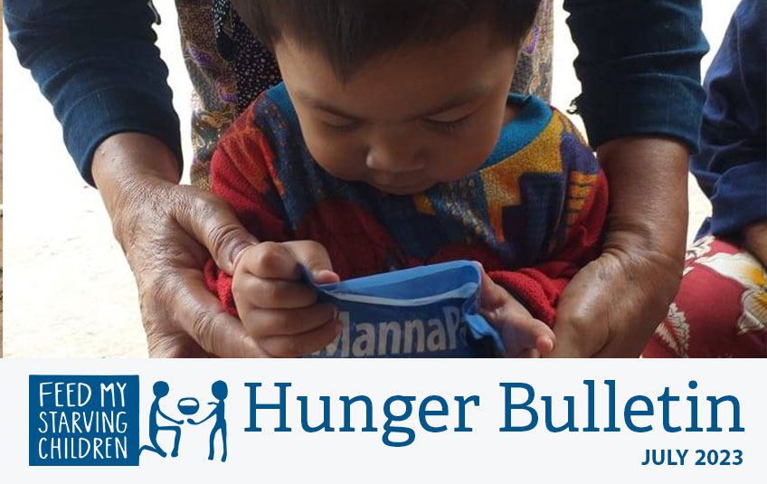 Photo of mother and child receiving MannaPack meal in Myanmar