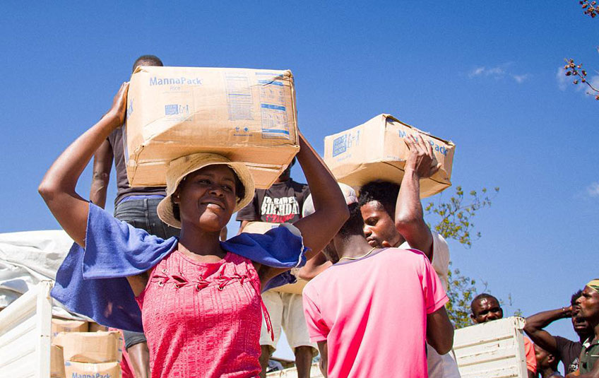 Unloading MannaPack meals from truck in Haiti