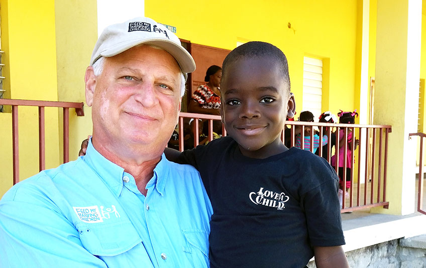 FMSC CEO Mark Crea with a child