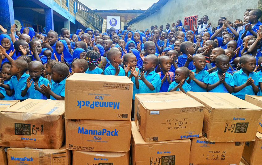 A group of kids with boxes of FMSC food in Sierra Leone