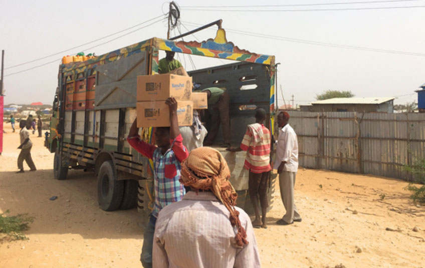 People unloading a truck of FMSC food in Somalia