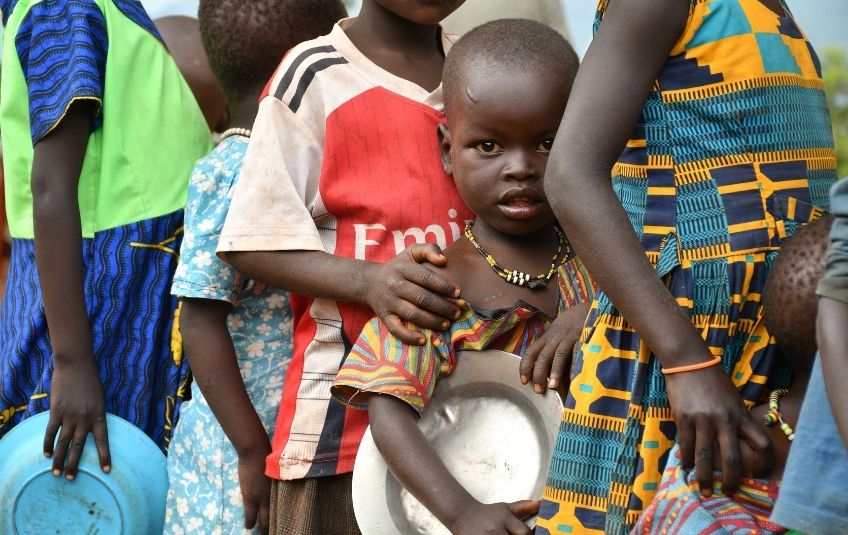 young girl with plate in line