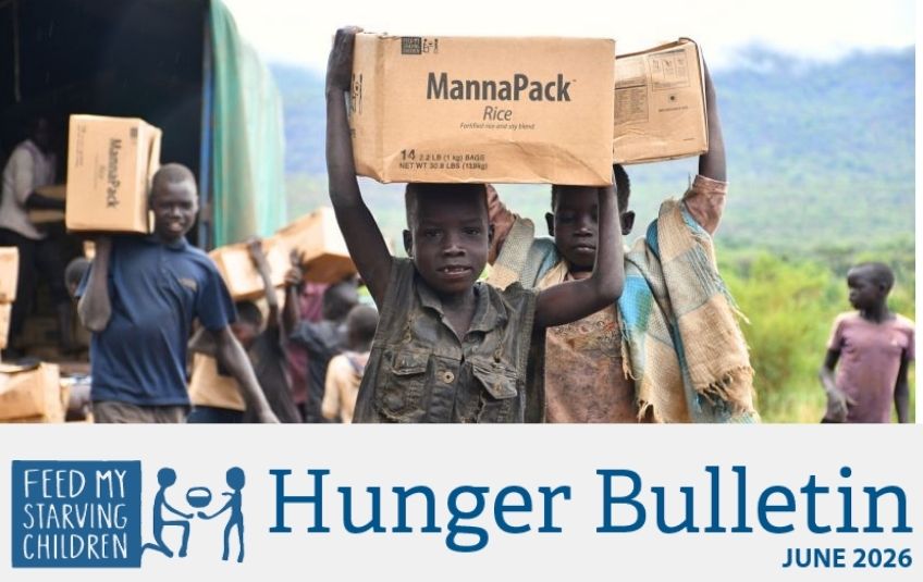 boys carrying FMSC boxes on their heads hunger bulletin header