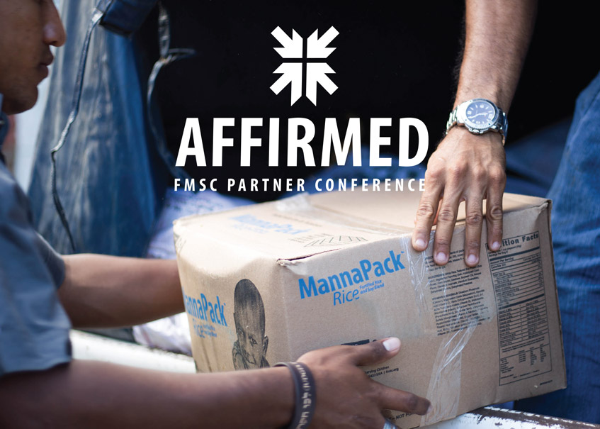 Two people holding a box of FMSC food, with the logo for FMSC's partner conference, Affirmed, set at the top center of the image.