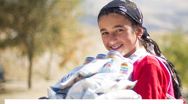 girl holding mannapack food packs