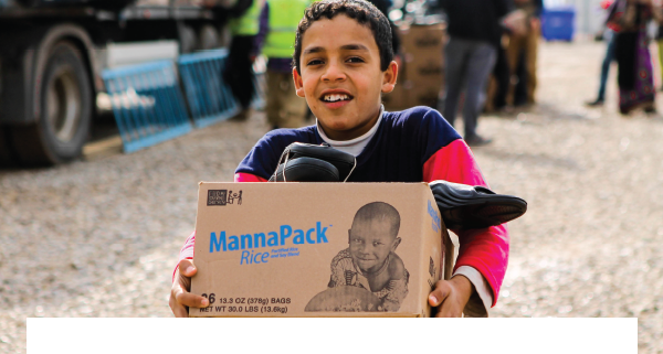 child holding MannaPack box full of food