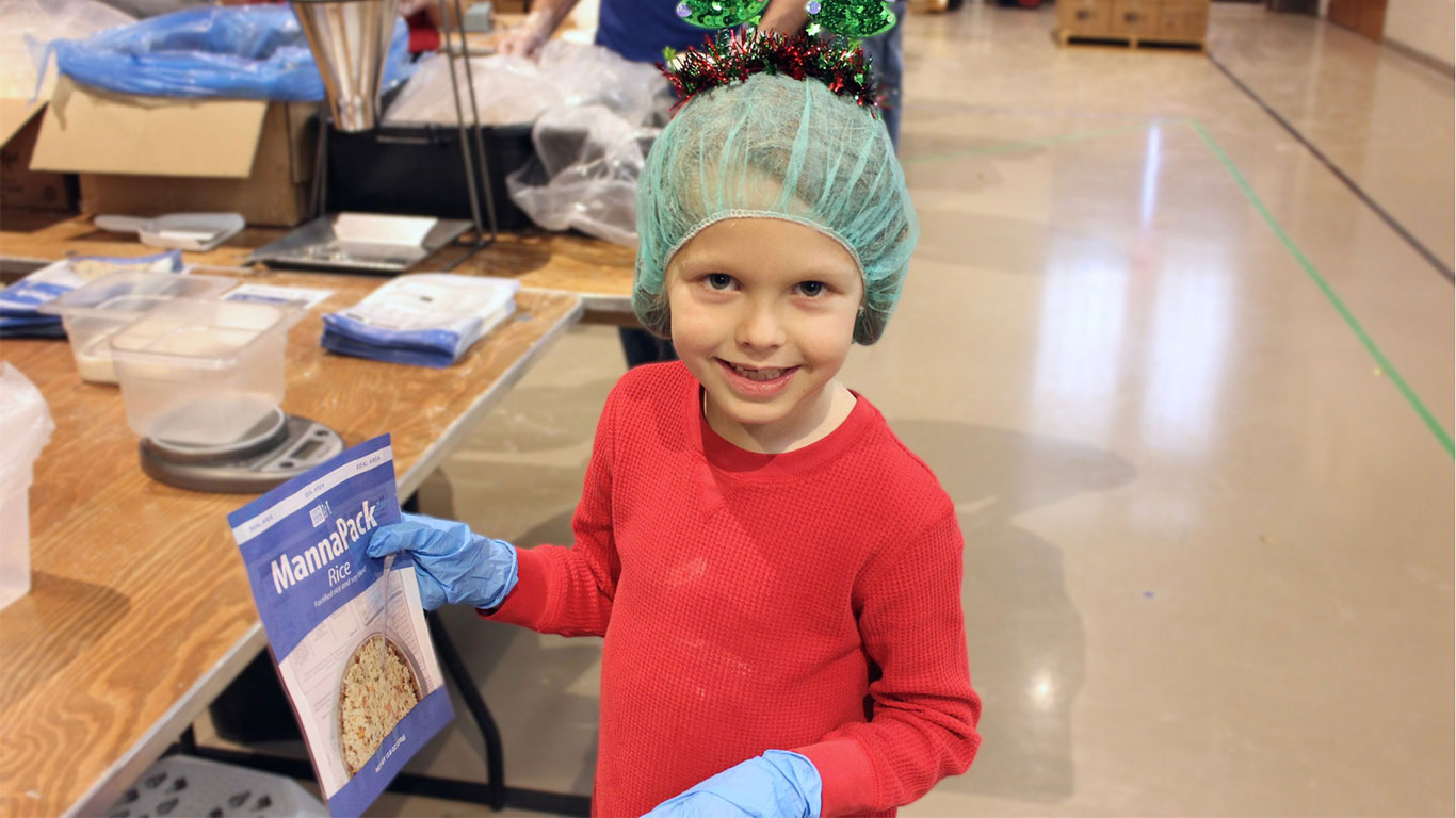 boy packing meals at an FMSC event in Illinois