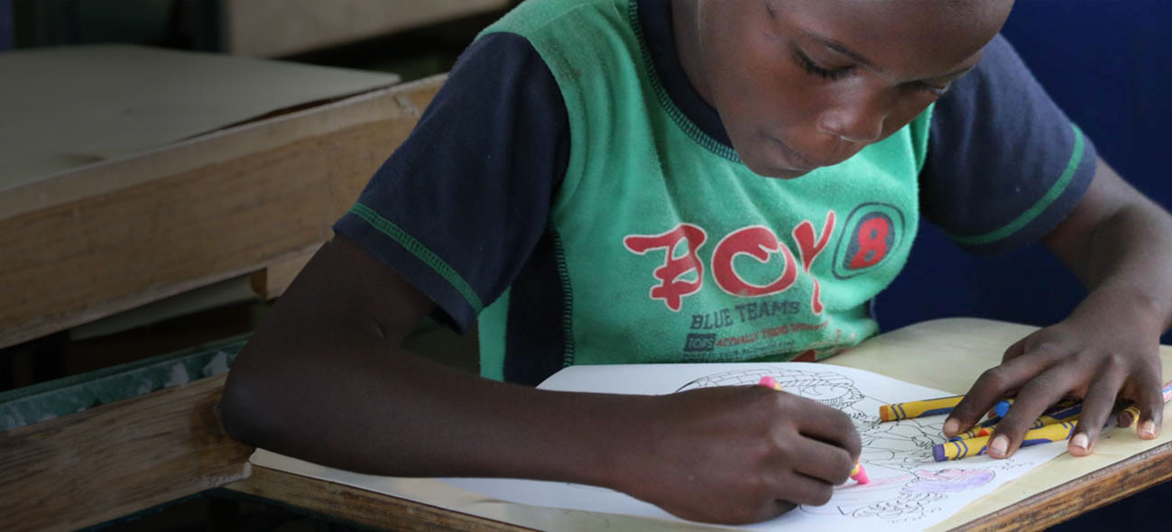 A girl coloring at a desk
