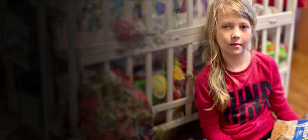 A Ukrainian girl sits holding a bag of MannaPack Rice