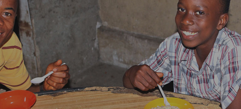 A child at a table eating FMSC food