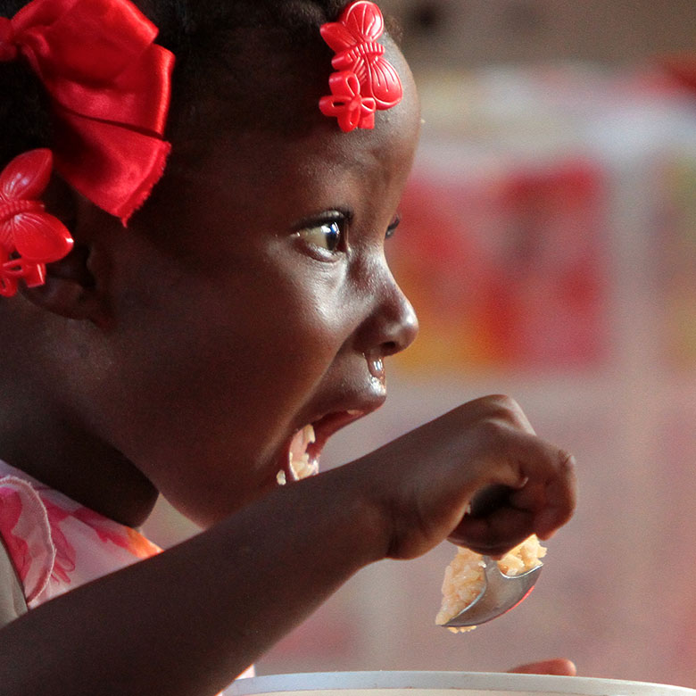 Child eating MannaPack Rice
