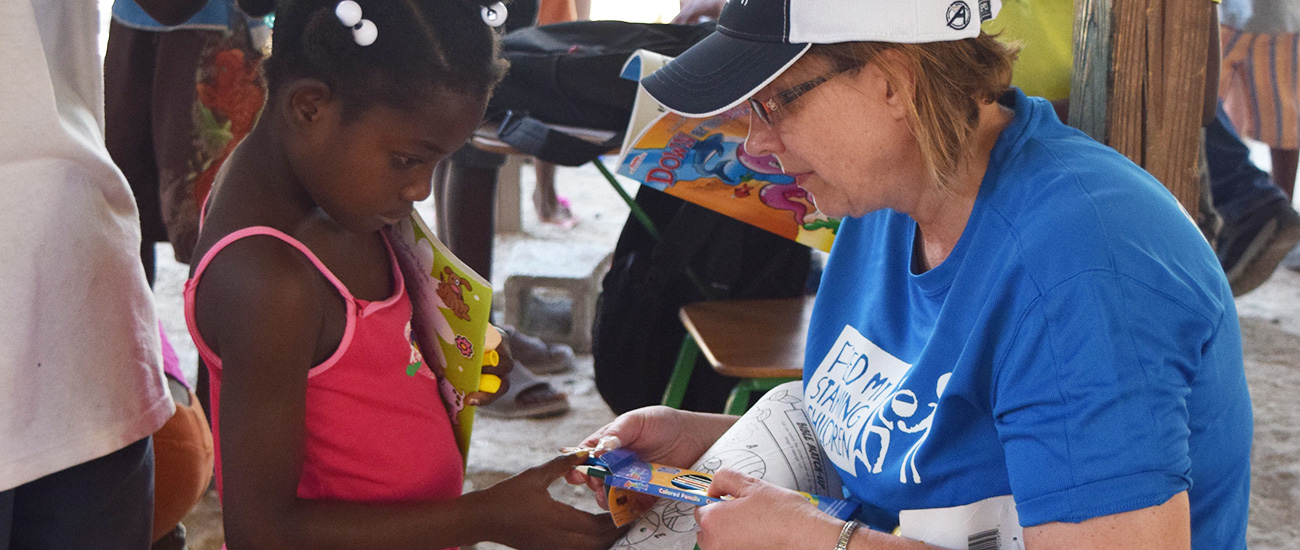 Giving a gift to a child in Haiti