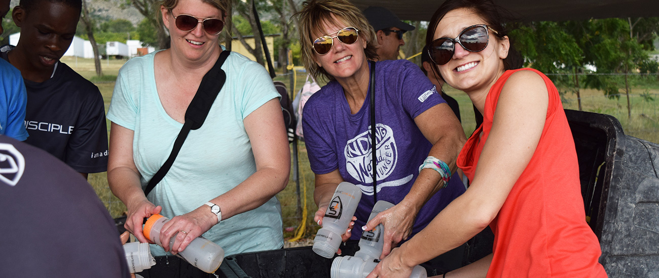 Washing water bottles at Sport Disciple in Haiti