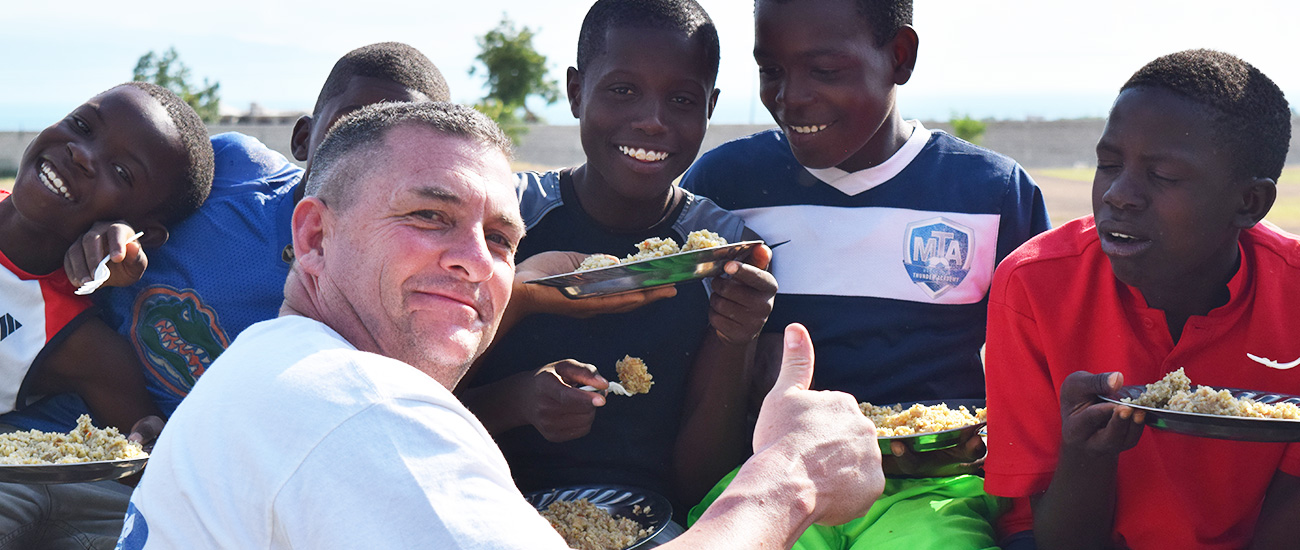 Feeding children at Sport Disciple in Haiti